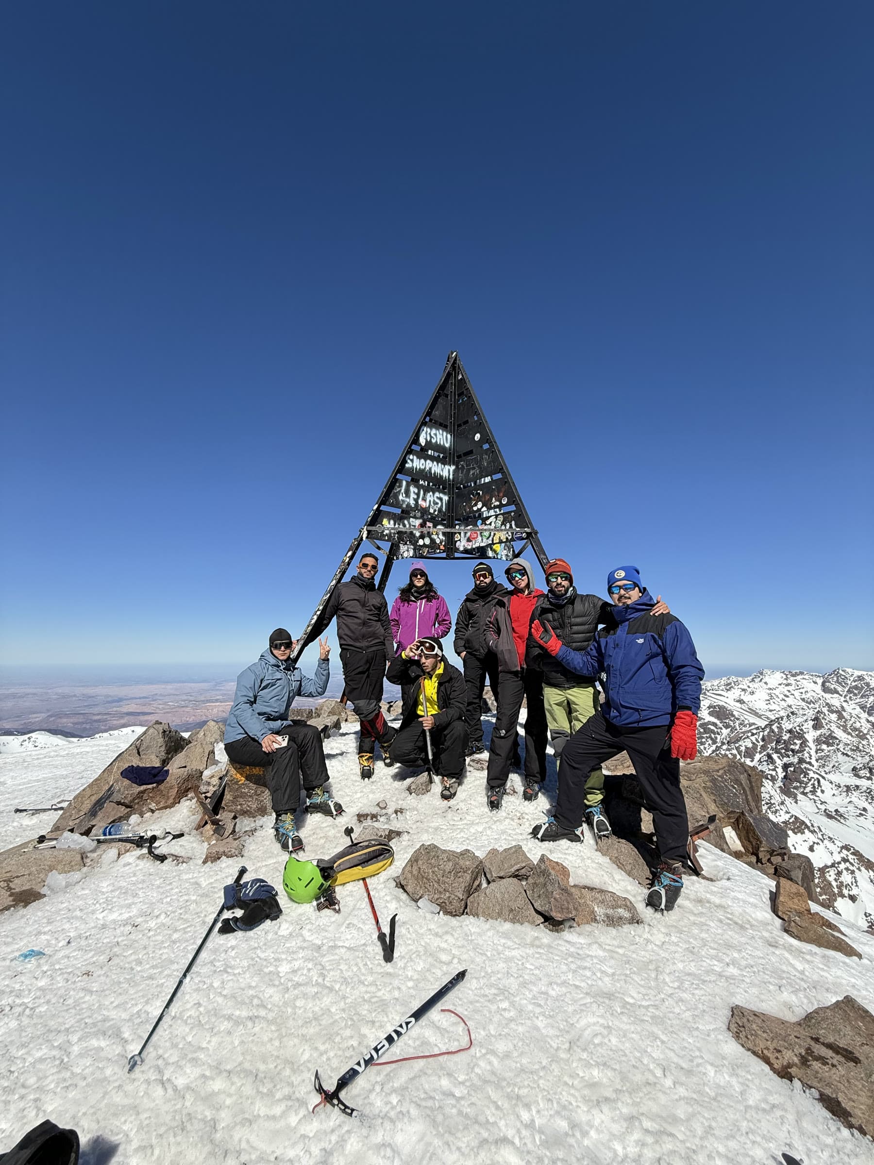 The summit party gathered under the metal pyramid at 4,167 m